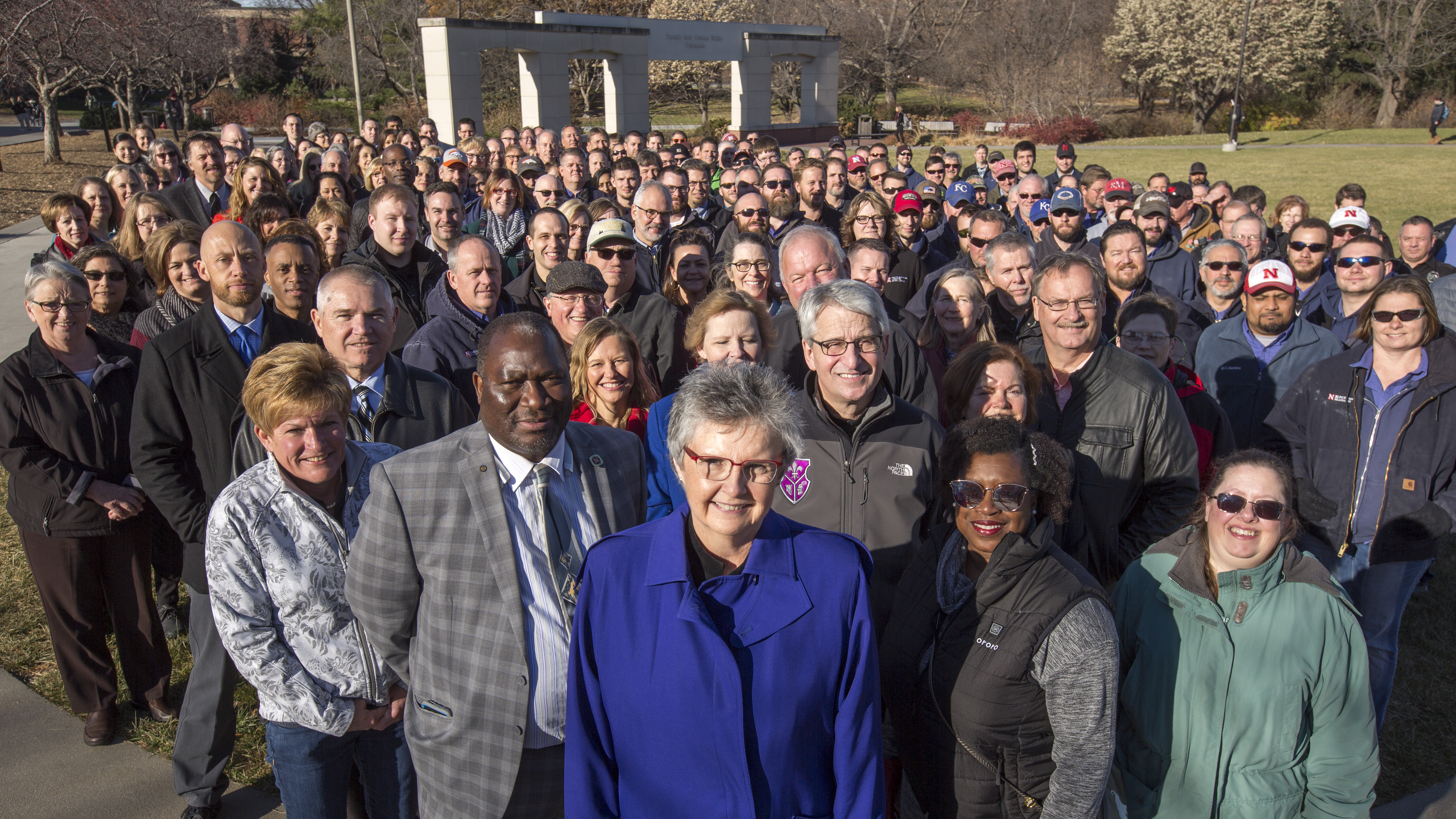 Christine Jackson (front, center, in blue coat) stands with more than 200 Business and Finance employees on the Nebraska Union Plaza. The employees showed up to surprise Jackson for the photo. She is retiring at the end of December after 17 years of service as Nebraska's vice chancellor for business and finance.