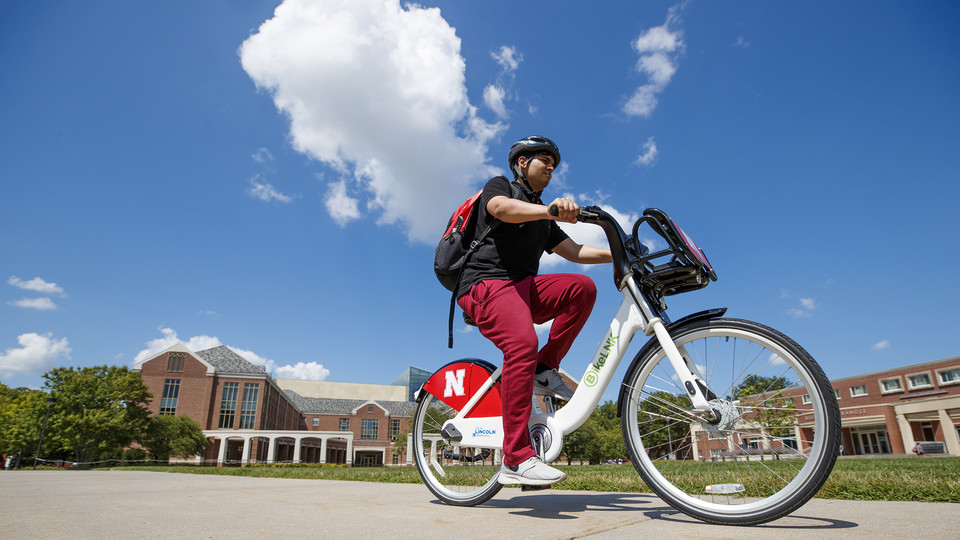 Achintya Handa rides a BikeLNK cruiser across campus in this file photo from 2018. The university earning a Bicycle Friendly Business platinum award is one of the factors that contributed to the gold rating in the STARS program.  