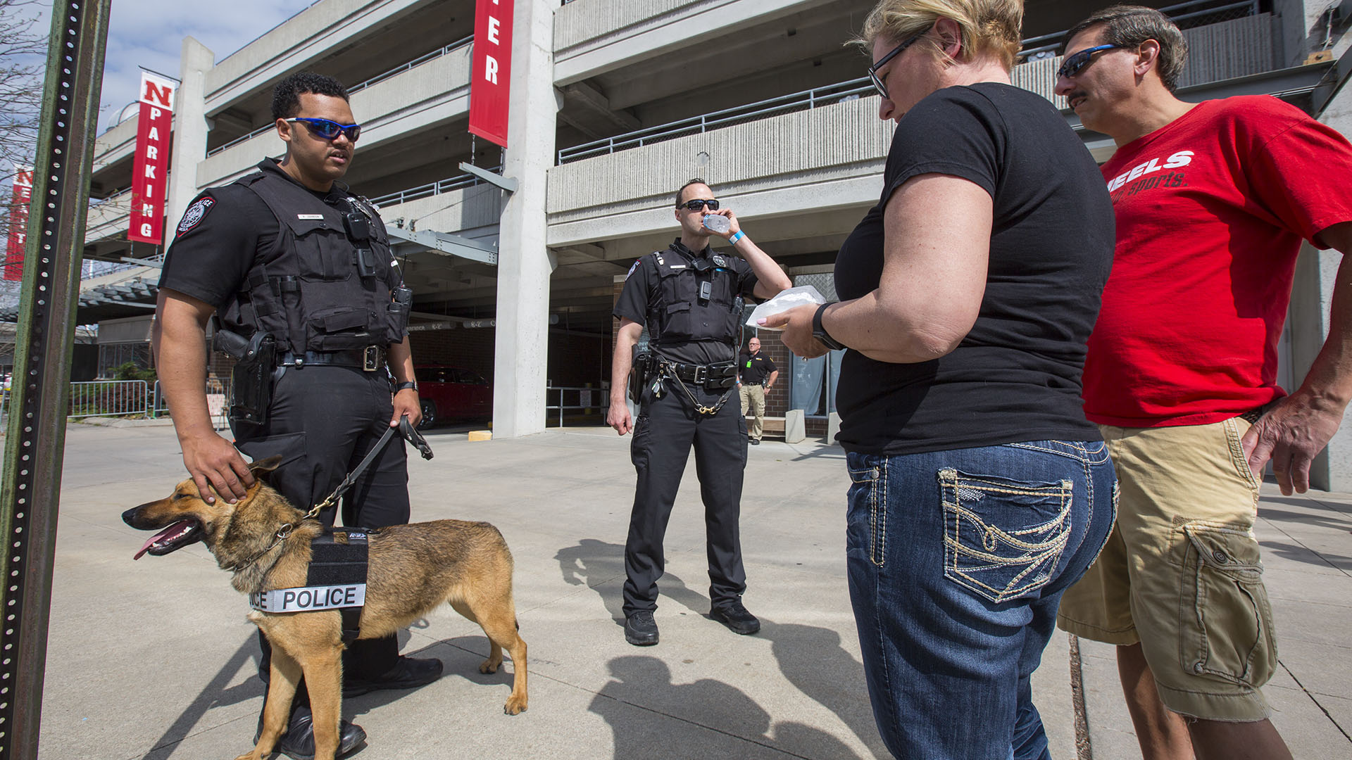 Nebraska K-9 officers Russell Johnson Jr. (left) and Greg Byelick talk with Husker fans prior to the Husker football spring game on April 15. The University Police Department has launched a new effort to expand outreach to the campus community.