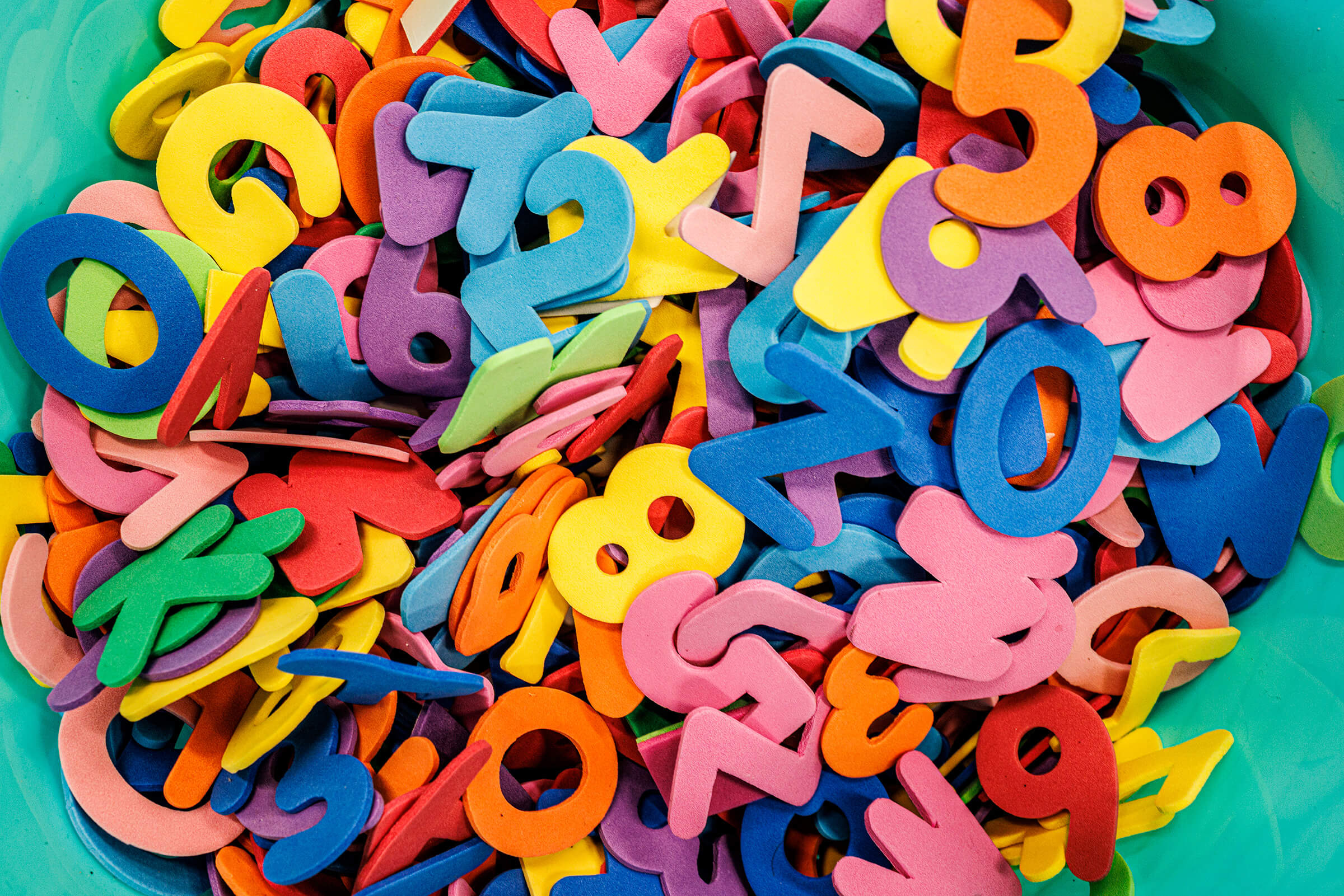 Bucket of colorful foam letters