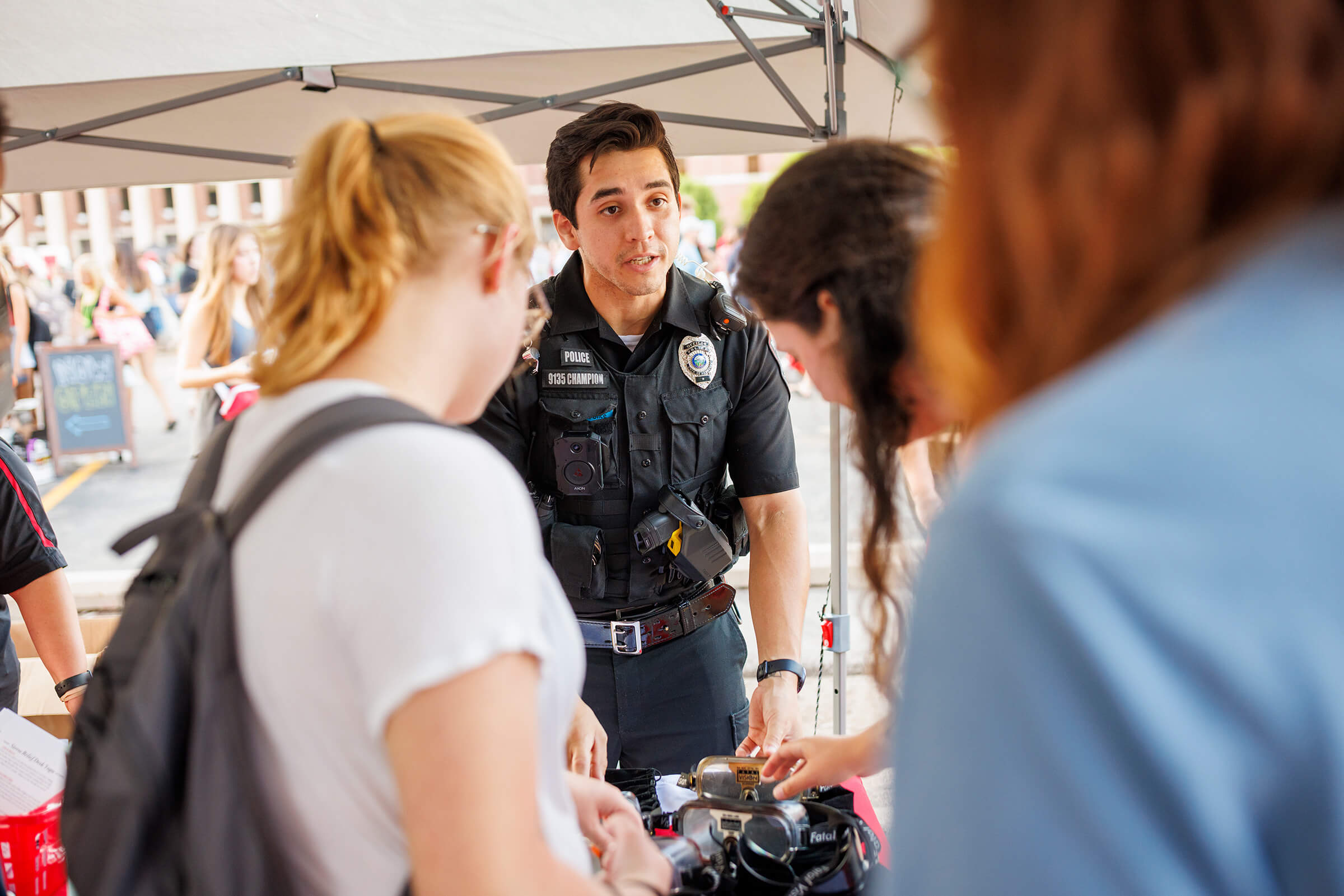 Students talking with campus police at campus festival