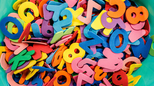 Bucket of colorful foam letters
