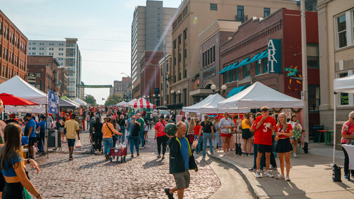 Farmers market in downtown Lincoln Haymarket area with people shopping for goods