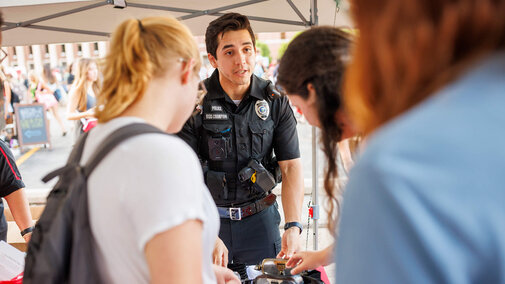 Students talking with campus police at campus festival
