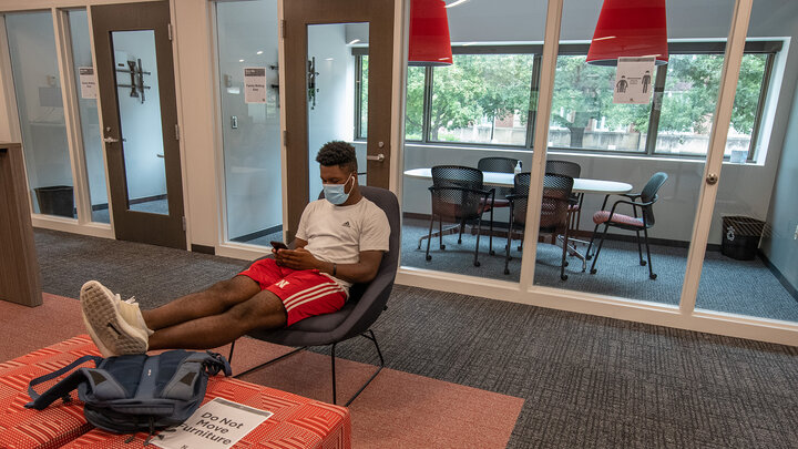Tedum Npimnee, a junior international business major, waits for an appointment in the new Husker Hub office in Canfield Administration Building. Previously located in Pound Hall, Husker Hub recently moved into its remodeled space.