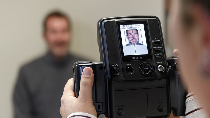 Scott Hurst has his picture taken Jan. 23 in the University of Nebraska-Lincoln Passport Office, 1700 Y St. The office is open 8 a.m. to 5 p.m. Monday through Friday.