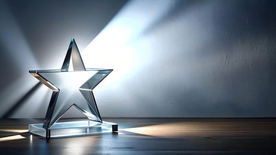 Glass star award with light reflecting through it