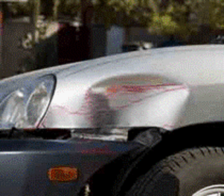 medium sized dent and scratches on the side of a silver car