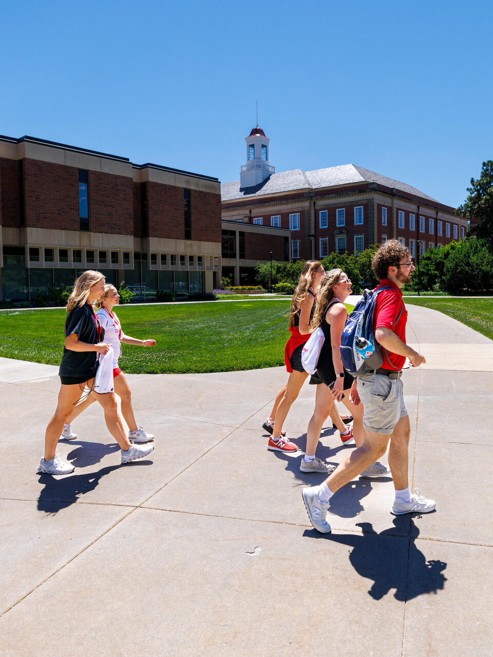 Students walking across campus on a sunny day